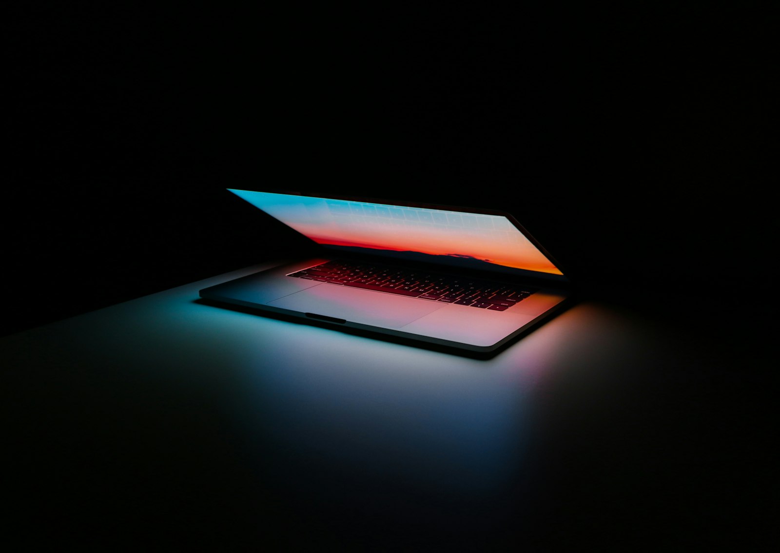 Laptop glowing in a dark studio